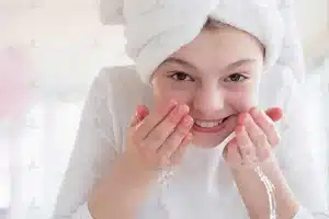 شستشوی ملایم صورت با آب برای مراقبت از پوست در آکنه روزاسه